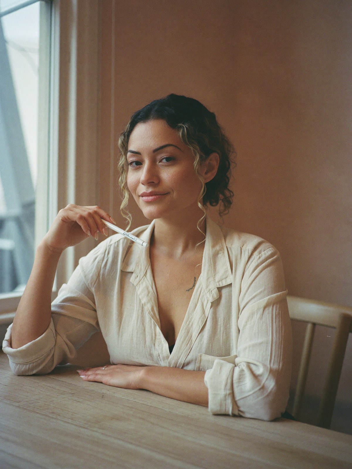 Sheyla at her table, holding a mapping pencil